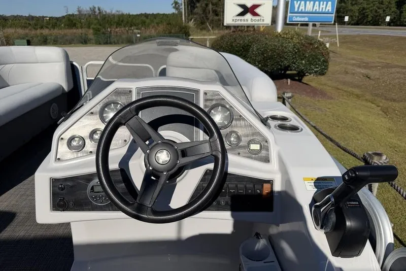 Slide: The Image of 2018 Godfrey SWEETWATER 2286 SB boat dashboard with steering wheel and controls. - 15