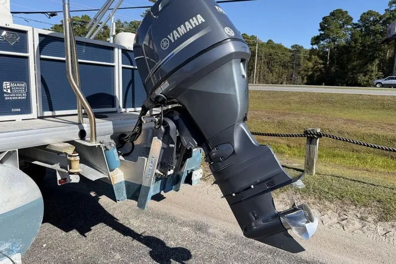 Slide: The Image of 2018 Godfrey SWEETWATER 2286 SB with Yamaha outboard motor, parked on roadside. - 17