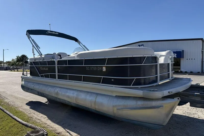 Slide: The Image of 2018 Godfrey SWEETWATER 2286 SB pontoon boat parked outdoors on a sunny day. - 6
