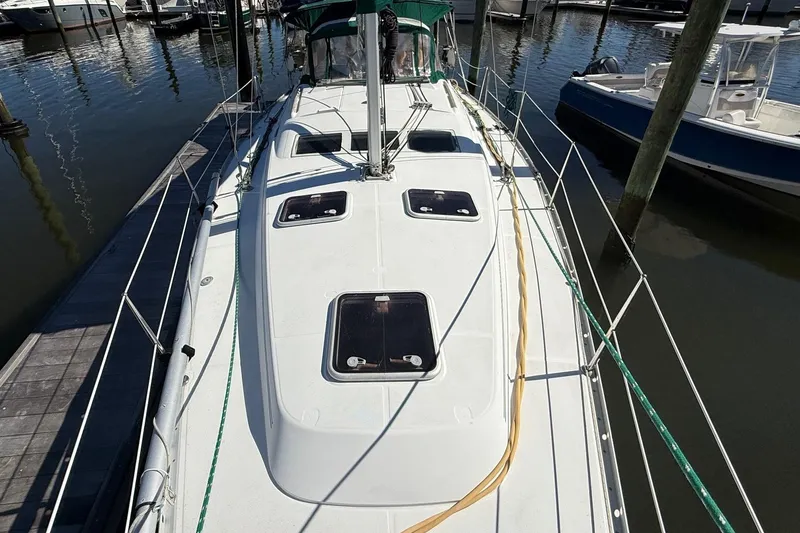 Slide: The Image of 2005 Beneteau Oceanis 373 sailboat docked, showcasing deck and hatches. - 12