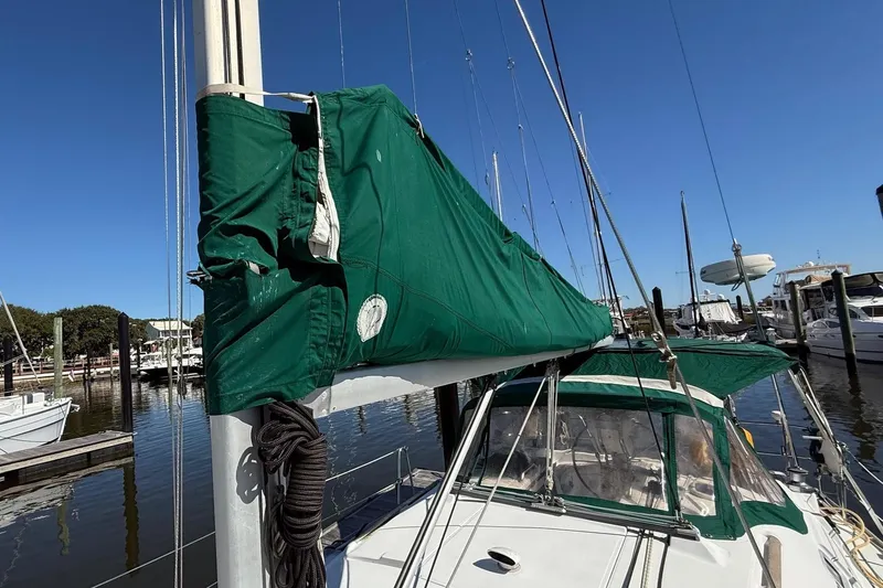 Slide: The Image of 2005 Beneteau Oceanis 373 sailboat with green sail cover docked at marina. - 14