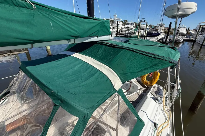 Slide: The Image of 2005 Beneteau Oceanis 373 sailboat with green canopy docked at marina. - 17