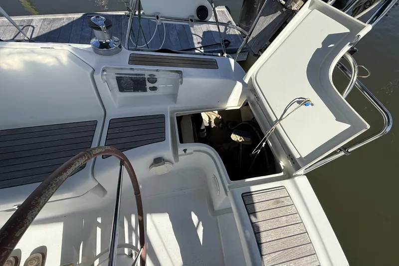 Slide: The Image of 2005 Beneteau Oceanis 373 cockpit with open storage hatch and steering wheel. - 20