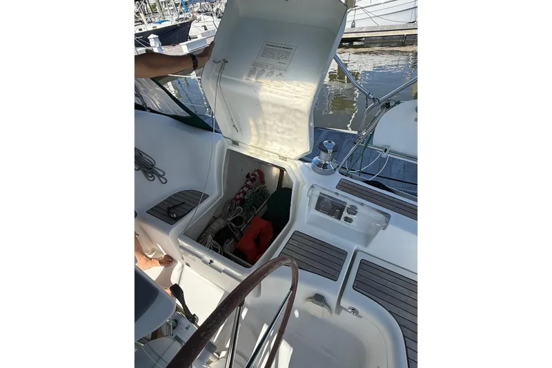 Slide: The Image of 2005 Beneteau Oceanis 373 sailboat cockpit with open storage compartment and visible equipment. - 21