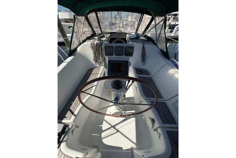 Slide: The Image of 2005 Beneteau Oceanis 373 sailboat cockpit with steering wheel and navigation instruments. - 25