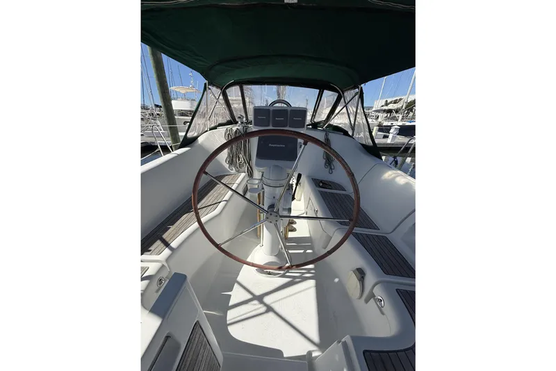 Slide: The Image of 2005 Beneteau Oceanis 373 sailboat cockpit with steering wheel and navigation equipment. - 28