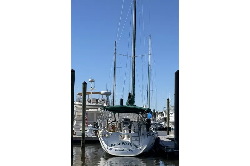 Slide: The Image of 2005 Beneteau Oceanis 373 sailboat docked at marina under clear blue sky. - 3