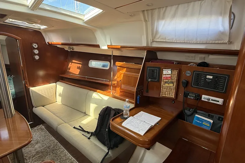 Slide: The Image of Interior of 2005 Beneteau Oceanis 373 sailboat with cozy seating and navigation station. - 33