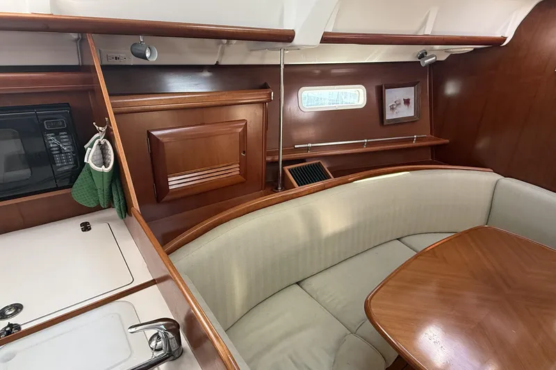 Slide: The Image of Interior of 2005 Beneteau Oceanis 373 sailboat with wood finish and cozy seating area. - 39
