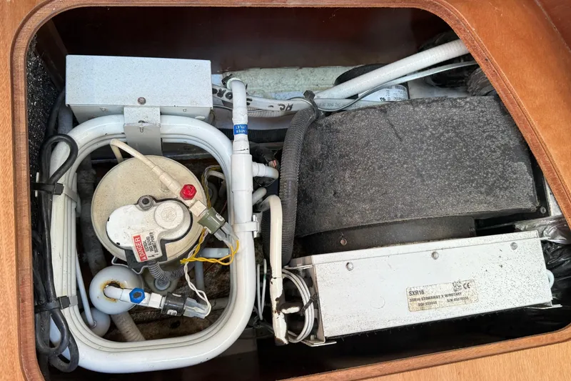 Slide: The Image of Engine compartment of a 2005 Beneteau Oceanis 373 sailboat, showcasing mechanical components. - 41
