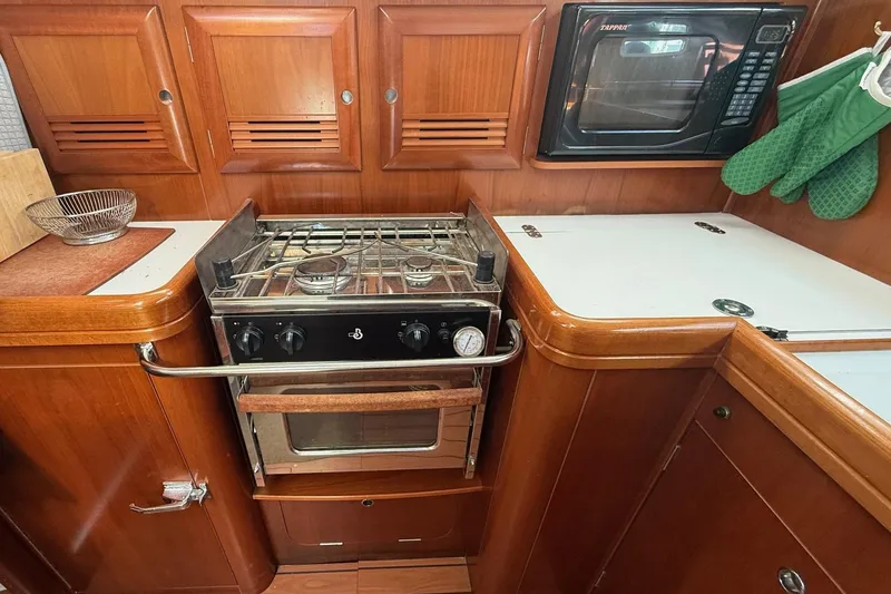 Slide: The Image of 2005 Beneteau Oceanis 373 yacht kitchen with stove, oven, and microwave. - 44