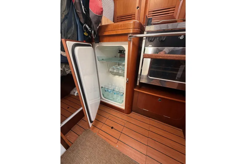 Slide: The Image of Interior of 2005 Beneteau Oceanis 373 yacht with open fridge and oven. - 46