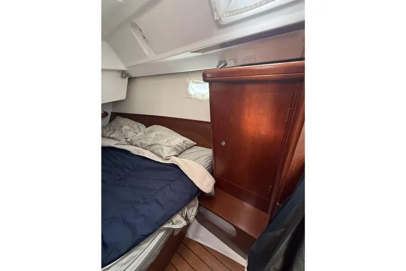 Slide: The Image of Cozy cabin interior of 2005 Beneteau Oceanis 373 sailboat with wooden cabinetry and bedding. - 48