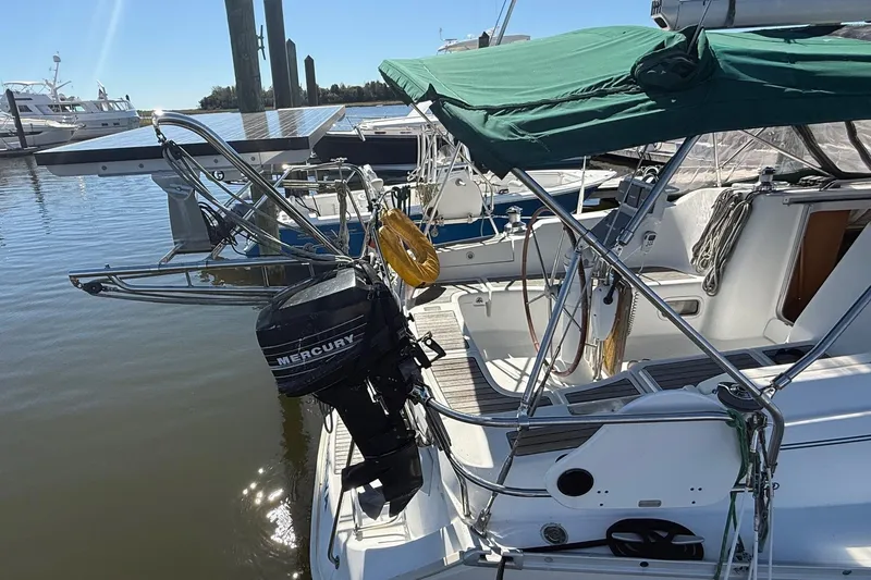 Slide: The Image of 2005 Beneteau Oceanis 373 sailboat with green canopy and Mercury outboard motor. - 5