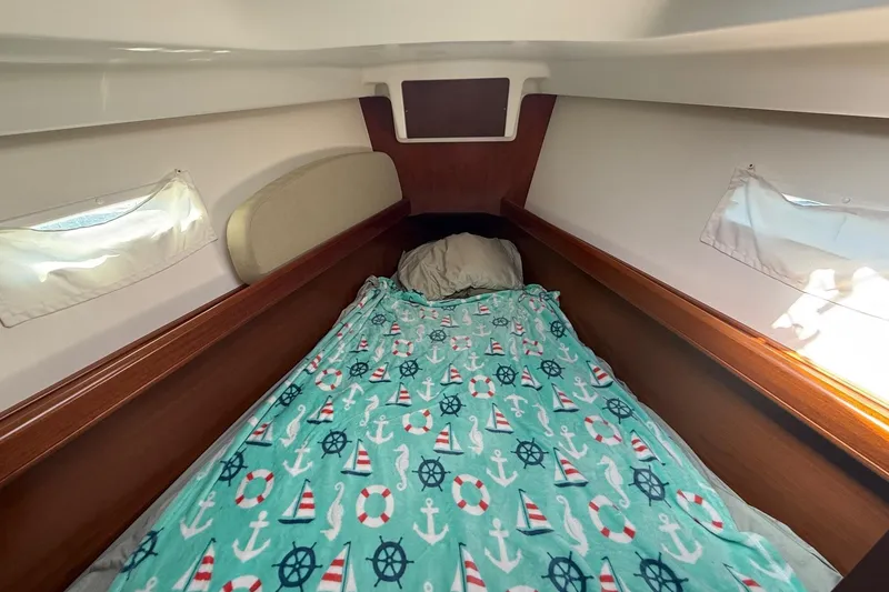 Slide: The Image of Cozy cabin interior of 2005 Beneteau Oceanis 373 with nautical-themed bedding. - 51