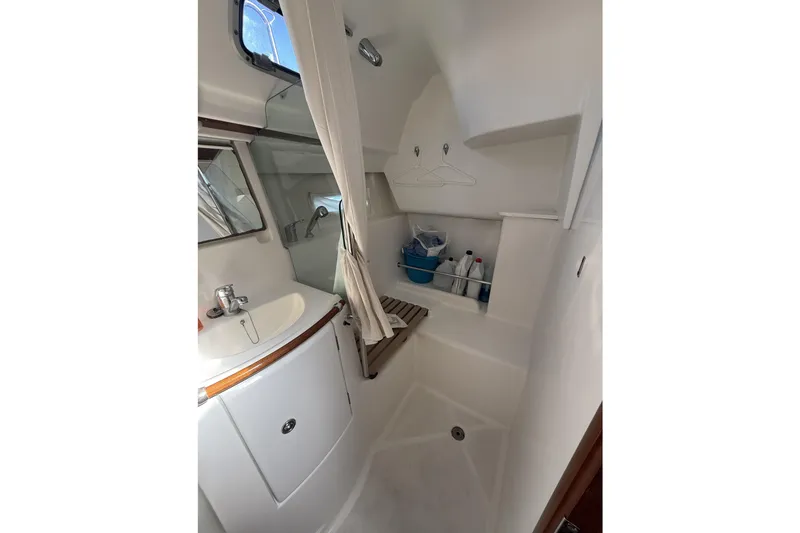 Slide: The Image of 2005 Beneteau Oceanis 373 bathroom with sink, shower, and storage space. - 53