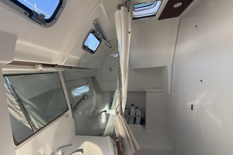 Slide: The Image of Interior of 2005 Beneteau Oceanis 373 yacht bathroom with shower and porthole windows. - 55
