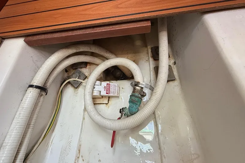 Slide: The Image of Bilge area of 2005 Beneteau Oceanis 373 with hoses and valve. - 56