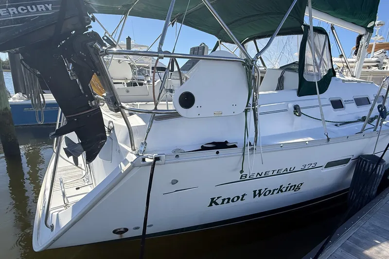 Slide: The Image of 2005 Beneteau Oceanis 373 sailboat named "Knot Working" docked with Mercury outboard. - 6