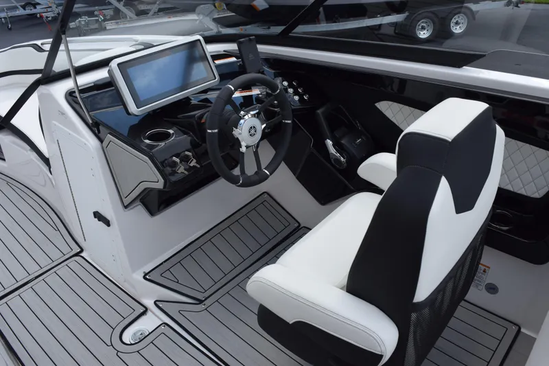 Slide: The Image of 2026 Yamaha Boats 252S cockpit with modern steering and touchscreen display. - 13