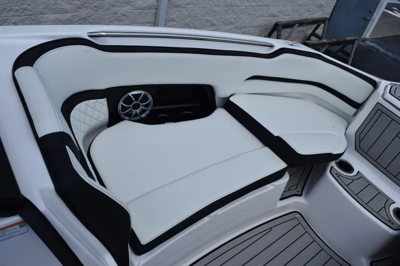 Slide: The Image of Luxurious seating area on 2026 Yamaha Boats 252S, featuring sleek white and black upholstery. - 18