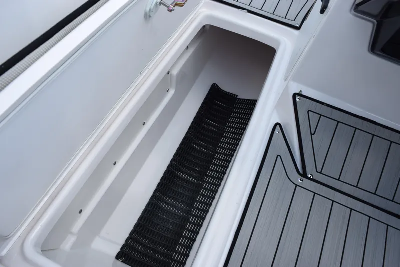 Slide: The Image of 2026 Yamaha Boats 252S storage compartment with sleek, modern design and non-slip flooring. - 19