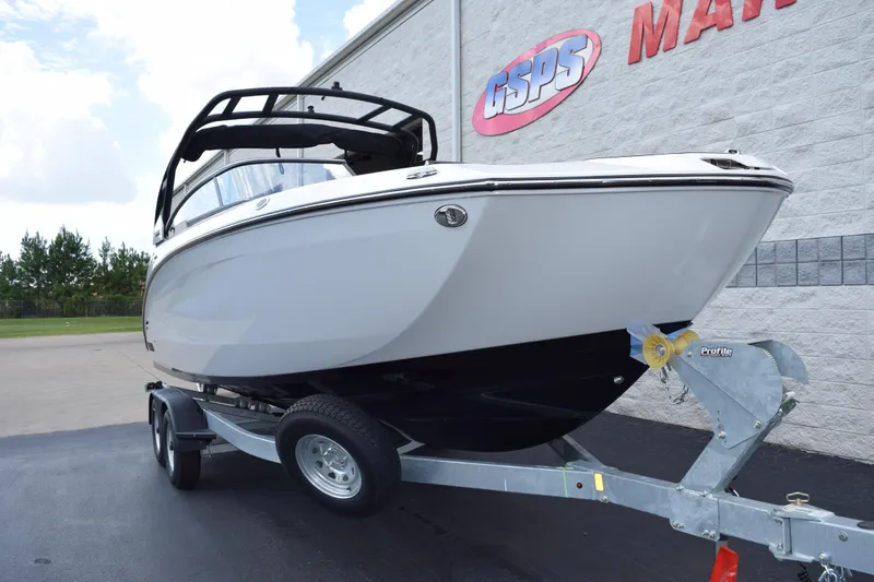 Slide: The Image of 2026 Yamaha Boats 252S on trailer outside dealership building. - 2