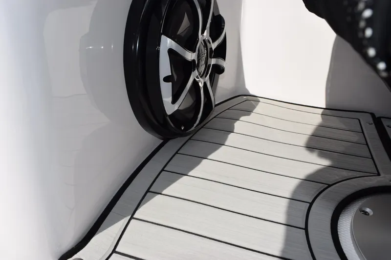 Slide: The Image of 2026 Yamaha Boats 252S interior with speaker and sleek flooring design. - 21