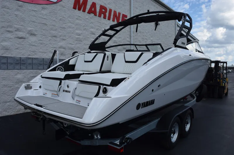 Slide: The Image of 2026 Yamaha Boats 252S on trailer, sleek design, white exterior, parked outdoors. - 4