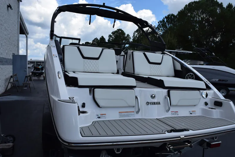 Slide: The Image of 2026 Yamaha Boats 252S with sleek white seating and modern design, docked outdoors. - 5