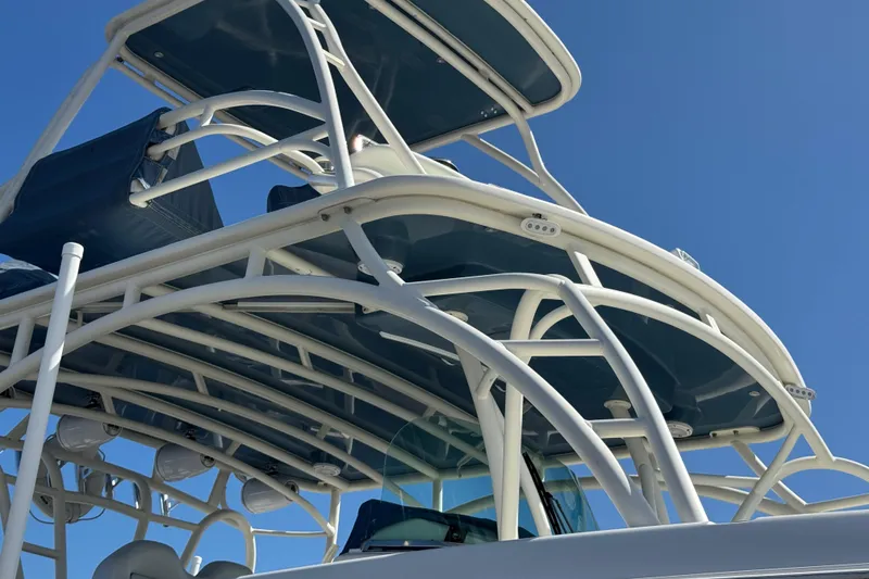Slide: The Image of 2012 Hydra-Sports 4200 Siesta boat with intricate white framework against blue sky. - 2