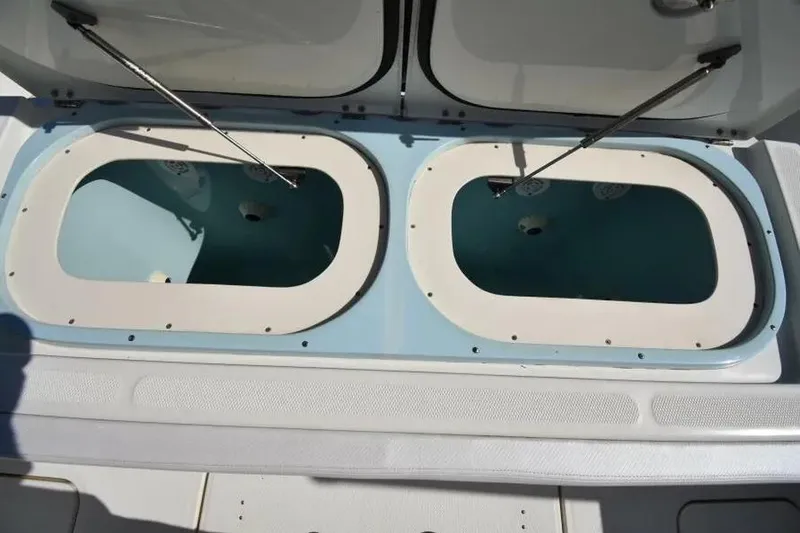 Slide: The Image of 2012 Hydra-Sports 4200 Siesta boat with open dual storage compartments. - 23