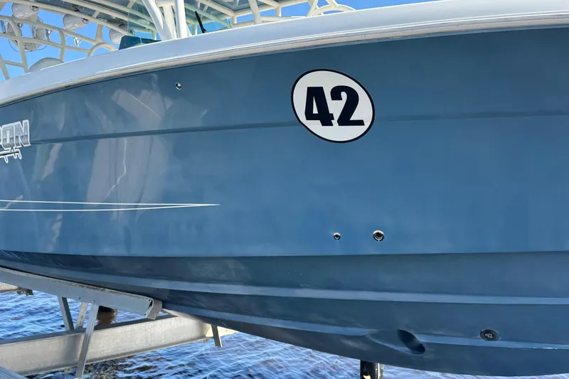 Slide: The Image of 2012 Hydra-Sports 4200 Siesta boat with number 42 on blue hull. - 26