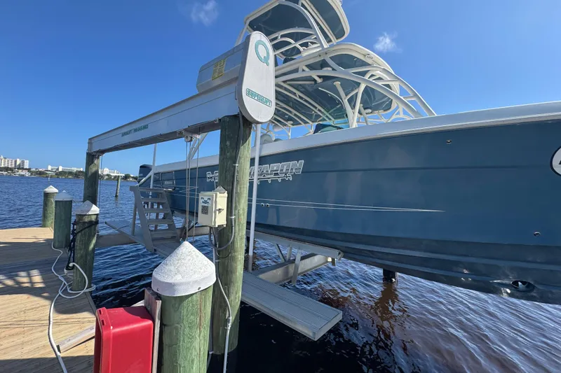 Slide: The Image of 2012 Hydra-Sports 4200 Siesta boat on lift at dockside, clear blue sky. - 27