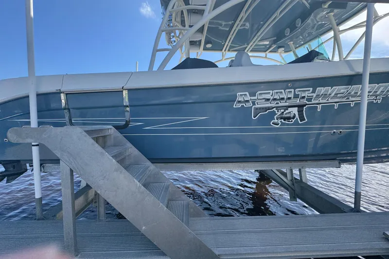 Slide: The Image of 2012 Hydra-Sports 4200 Siesta boat on lift, side view with custom graphics. - 28