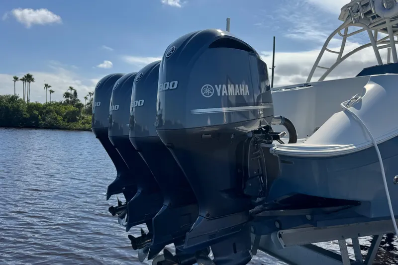 Slide: The Image of Four Yamaha outboard motors on a 2012 Hydra-Sports 4200 Siesta boat, docked by the water. - 30