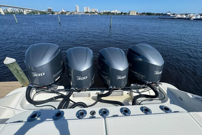 Slide: The Image of 2012 Hydra-Sports 4200 Siesta with four Yamaha 300 outboard engines on a calm waterfront. - 31