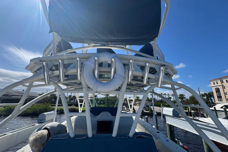 Slide: The Image of 2012 Hydra-Sports 4200 Siesta boat with upper deck and life preserver, docked under clear sky. - 32