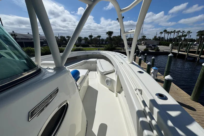 Slide: The Image of 2012 Hydra-Sports 4200 Siesta boat docked, showcasing sleek design and spacious deck. - 36