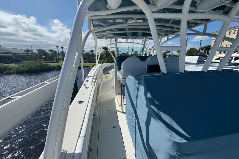 Slide: The Image of 2012 Hydra-Sports 4200 Siesta boat docked, featuring spacious deck and covered seating area. - 48