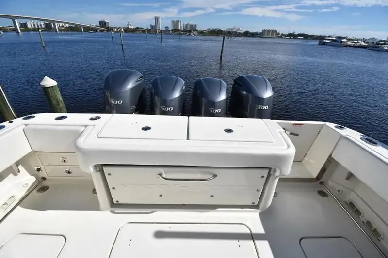 Slide: The Image of 2012 Hydra-Sports 4200 Siesta boat with four powerful outboard engines on a calm waterway. - 5