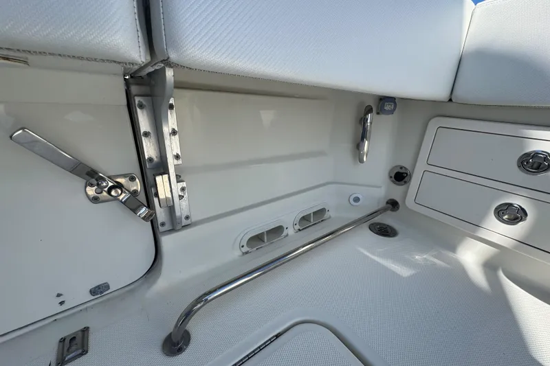Slide: The Image of Interior view of a 2012 Hydra-Sports 4200 Siesta boat, featuring seating and storage compartments. - 51