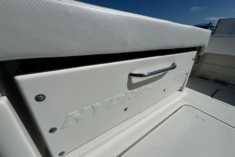 Slide: The Image of 2012 Hydra-Sports 4200 Siesta boat storage compartment with embossed logo and handle. - 53
