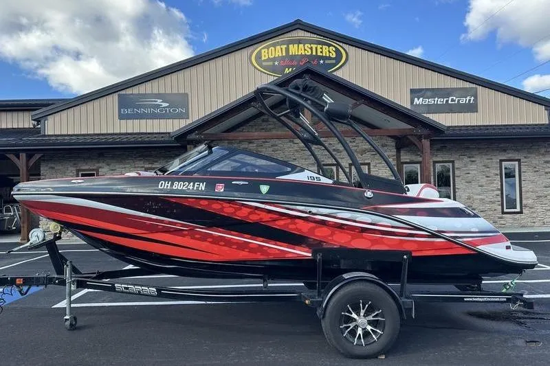 The Image of 2016 Scarab 195 H.O. boat on trailer, parked outside Boat Masters dealership. - 1