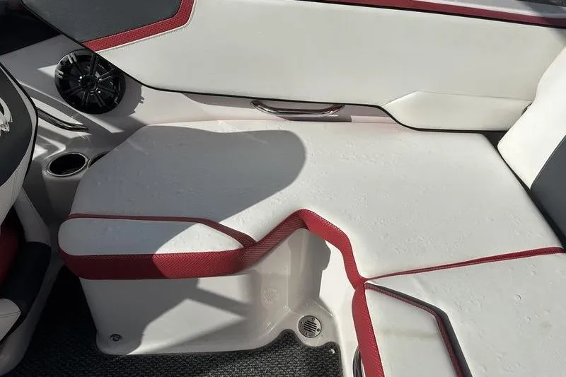 Slide: The Image of 2016 Scarab 195 H.O. boat interior with white and red seating, speaker, and cup holder. - 15