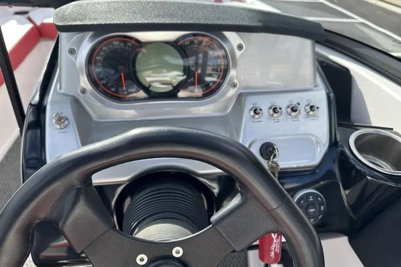 Slide: The Image of Dashboard of a 2016 Scarab 195 H.O. boat with steering wheel and gauges. - 19