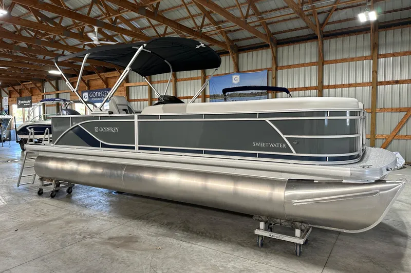 Slide: The Image of 2026 Godfrey Sweetwater 2286 C pontoon boat in a showroom setting. - 10