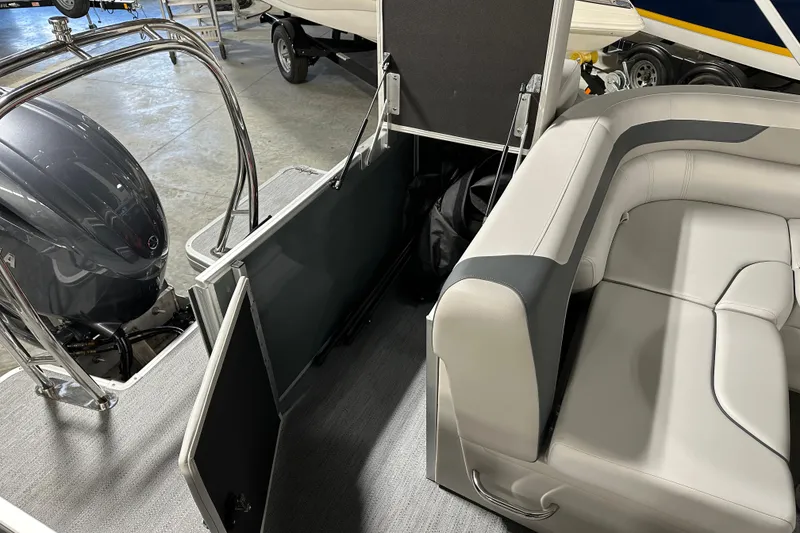 Slide: The Image of 2026 Godfrey Sweetwater 2286 C pontoon boat interior with seating and engine view. - 11