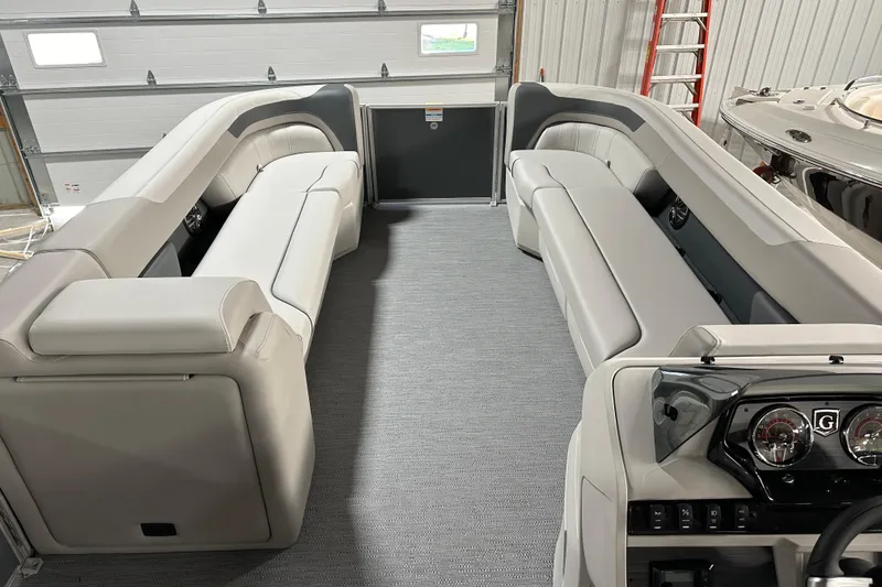 Slide: The Image of 2026 Godfrey Sweetwater 2286 C pontoon boat interior with plush seating and modern dashboard. - 13