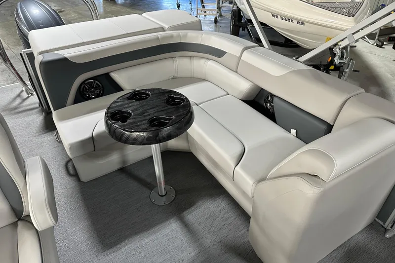 Slide: The Image of 2026 Godfrey Sweetwater 2286 C boat interior with plush seating and a round table. - 17